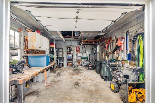 Garage featuring a workshop area | Image 39