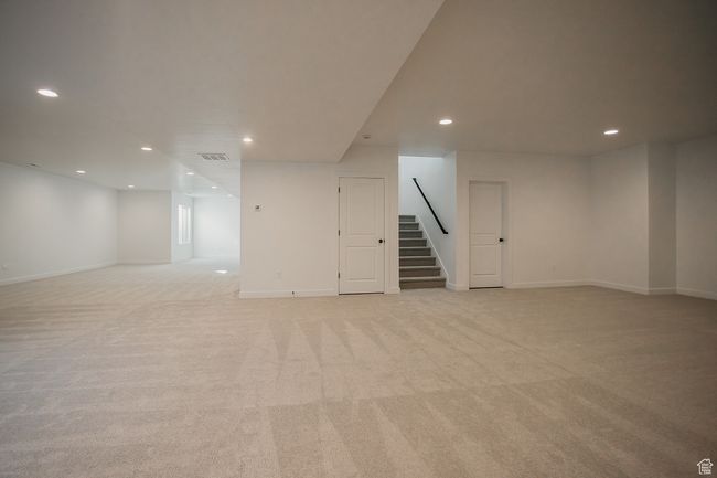 Finished below grade area with stairway, recessed lighting, light carpet, and baseboards | Image 36