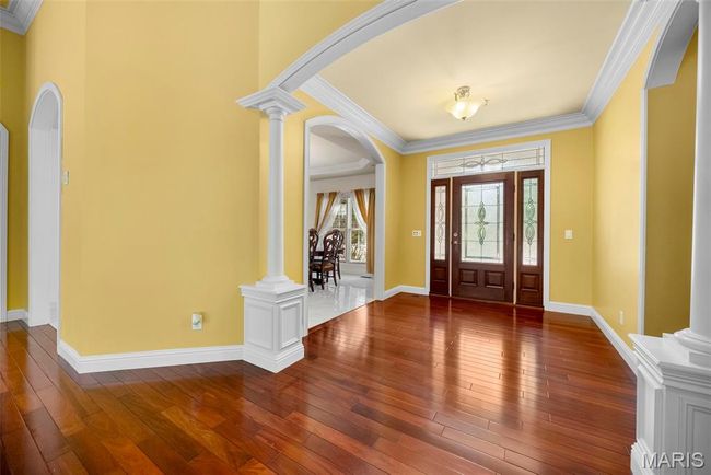 Welcoming entry foyer with cherrywood floors. | Image 7