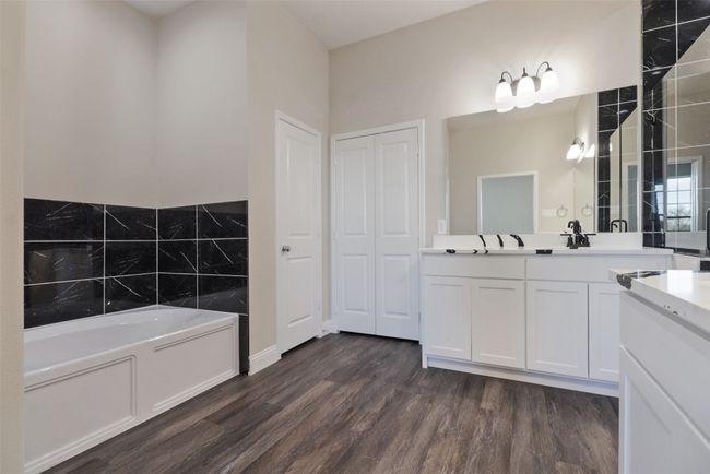 Bathroom featuring vanity, a garden tub, and wood finished floors | Image 11
