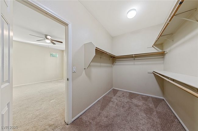 Spacious closet with carpet flooring and ceiling fan | Image 29