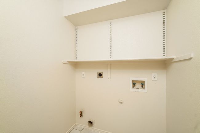 Laundry area with gas dryer hookup, hookup for a washing machine, hookup for an electric dryer, and tile patterned floors | Image 25