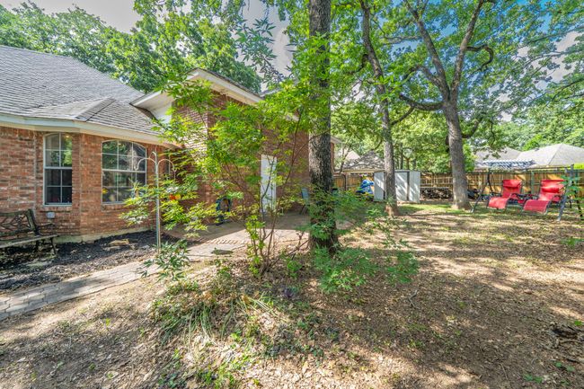 Fenced backyard featuring a storage shed | Image 25