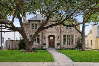 Fantastic curb appeal. Perfect symmetry. And shaded by two specimen live oak trees. Cast stone accents around every window and the front entry. Timeless quality. | Image 1