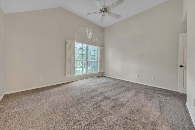 Spare room with ceiling fan, carpet, and high vaulted ceiling | Image 30
