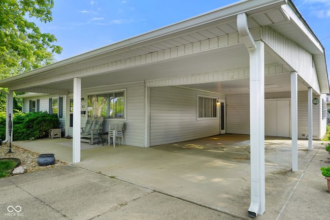 porch with an attached carport and driveway | Image 8