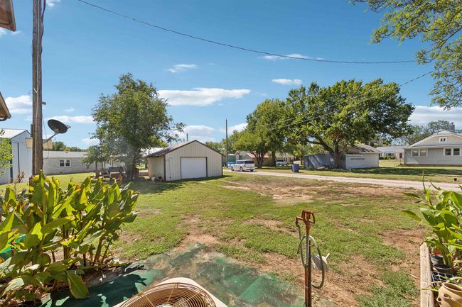 This garage has a dirt floor, electric, overhead door with opener and key pad | Image 23
