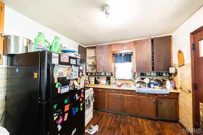 Kitchen featuring freestanding refrigerator, dark wood finished floors, light countertops, and open shelves | Image 12