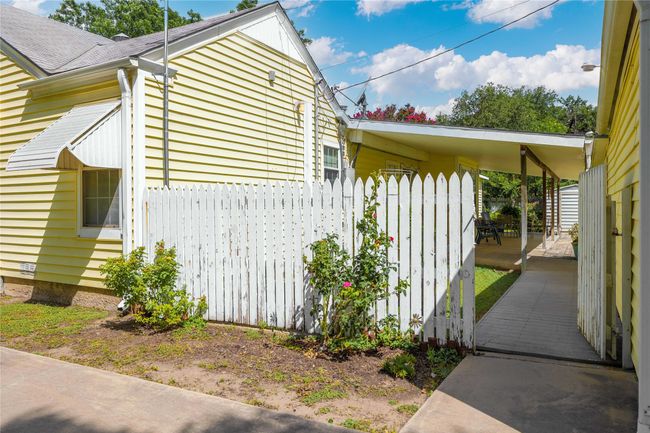 Side gate opened to additional parking and front of detached garage. | Image 38