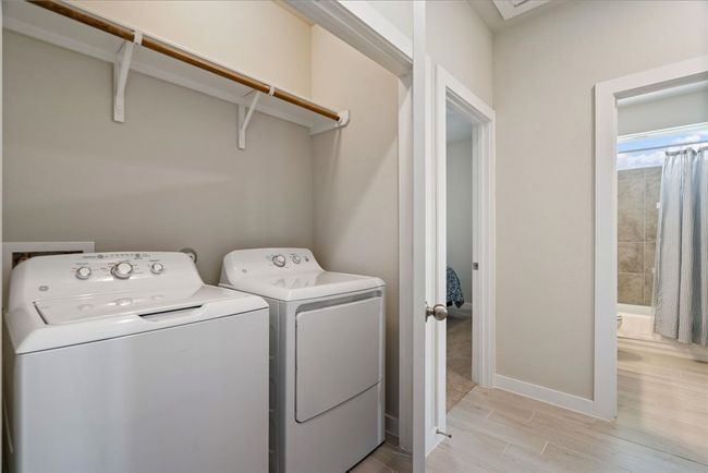 Washroom featuring independent washer and dryer and light wood finished floors | Image 22
