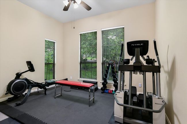 Exercise room with ceiling fan, closet, new carpet under workout floor (plywood base under gym floor padding). Can flex as a 5th bedroom. | Image 18