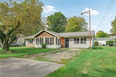 Ranch-style home featuring a front lawn and a sunroom | Image 3