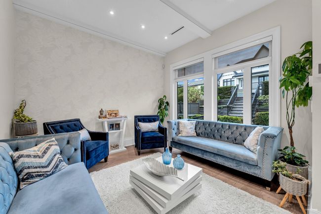 Living room featuring wood finished floors, wallpapered walls, beamed ceiling, baseboards, and recessed lighting | Image 16
