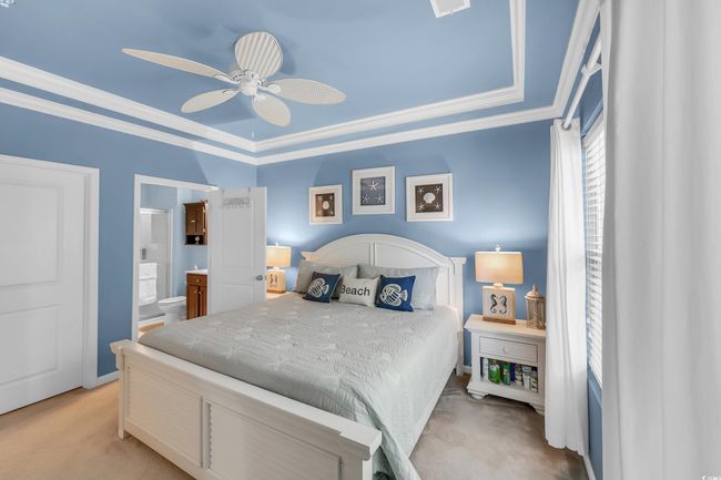 Bedroom with light colored carpet, ornamental molding, ensuite bathroom, and ceiling fan | Image 16