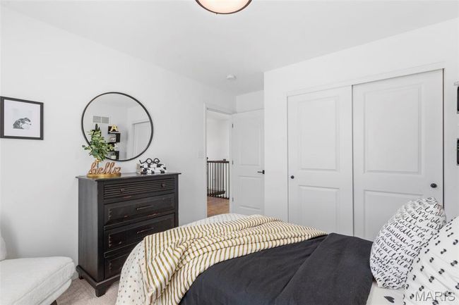 Bedroom featuring a closet and light carpet | Image 5