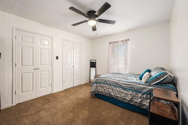 All secondary bedrooms are spacious and offer plush carpet, ceiling fans and ample closet space. | Image 16