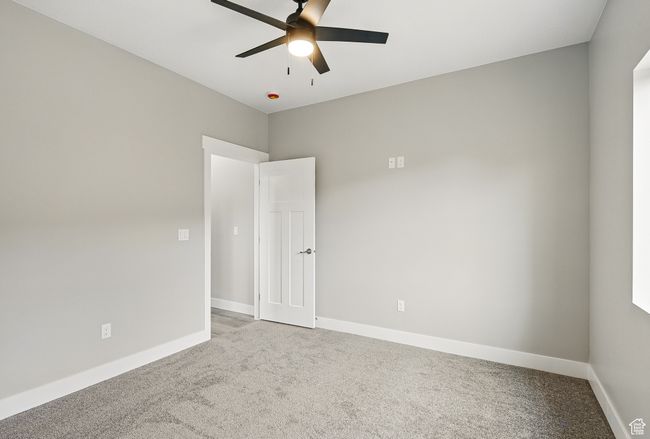 Spare room with light colored carpet, a ceiling fan, and baseboards | Image 37