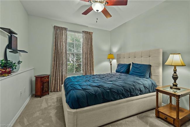 Bedroom featuring ceiling fan and light carpet | Image 14