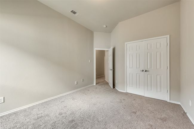 Unfurnished bedroom featuring carpet flooring, a closet, and vaulted ceiling | Image 26