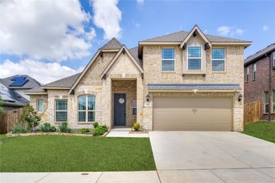 View of front of home featuring a front yard and a 2 car garage | Image 1