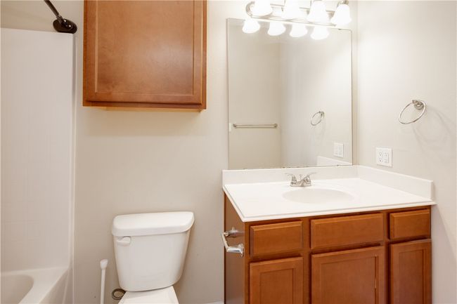 Bathroom with washtub / shower combination, toilet, and vanity | Image 11