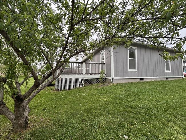 View of home's exterior featuring a lawn and a deck | Image 4