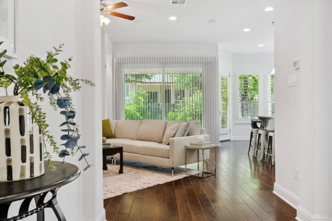 From the entry, you'll enjoy a direct line of sight to the stunning windows and doors the line the rear of the home. | Image 6