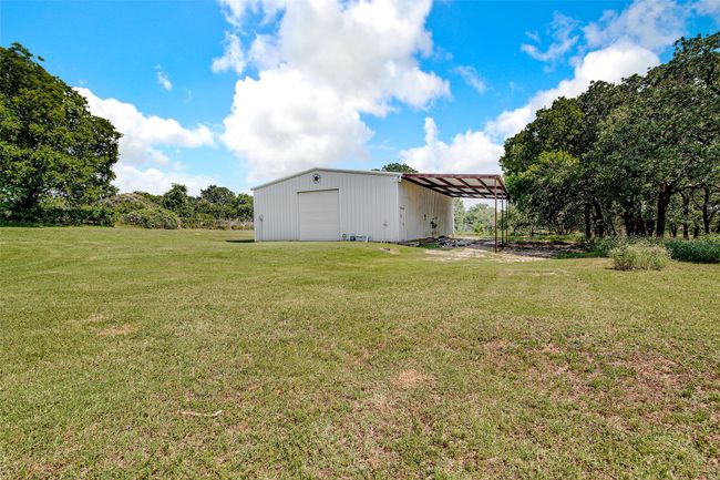 Side of the work shop with carport RV or boat parking | Image 37