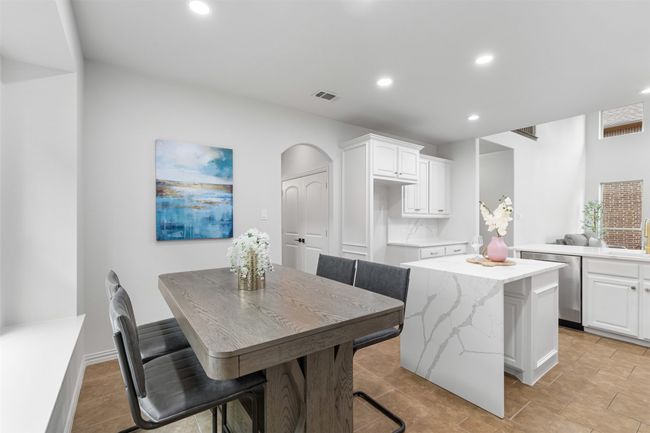 Kitchen featuring dishwasher, white cabinets, recessed lighting, and a center island | Image 20