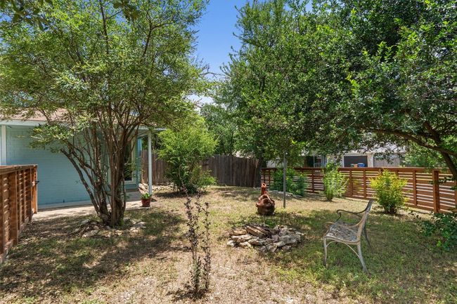 Fenced backyard with a fire pit | Image 27