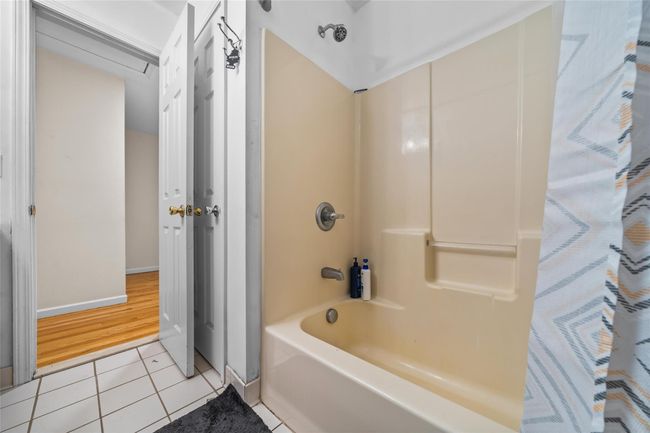 Full bathroom featuring tile patterned flooring, shower / tub combination, and baseboards | Image 34