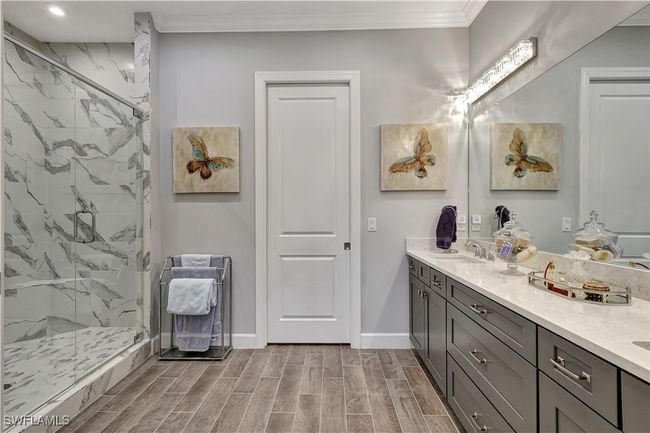 Ensuite with dual sinks and frameless glass shower door | Image 19