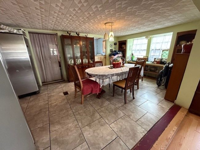 Dining area with light tile patterned floors | Image 29