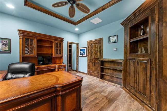 Home office featuring recessed lighting, ceiling fan, light wood-style flooring, and a tray ceiling | Image 48