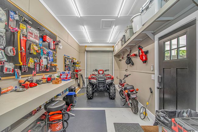 Garage with a workshop area | Image 24