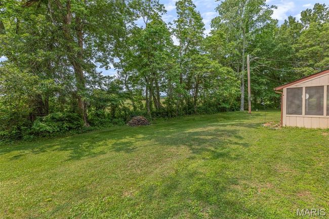 View of green lawn featuring a sunroom | Image 5