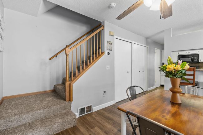 Easy access to the upper level from the dining area, featuring new carpeting on the stairs. | Image 14