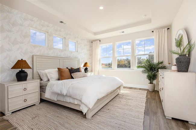 Bedroom with wallpapered walls, baseboards, light wood-type flooring, a raised ceiling, and recessed lighting | Image 20
