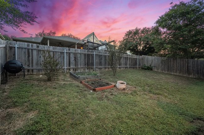 Relax on the covered back patio or deck offering the perfect spot to watch the sunset in your private, fenced in yard. | Image 34