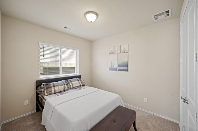 Fourth bedroom features largewindows and plush carpet. | Image 31