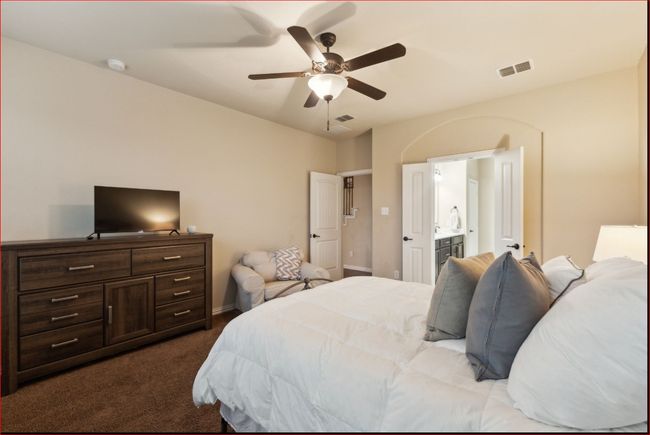 Bedroom featuring dark carpet, ensuite bathroom, and a ceiling fan | Image 16