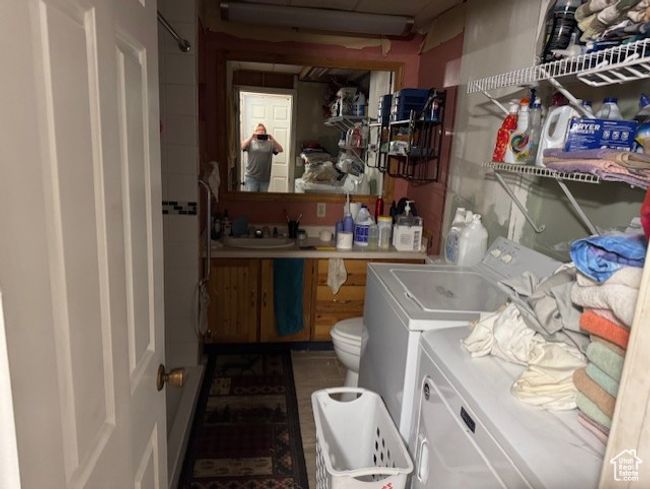 Laundry area with washer and clothes dryer | Image 8