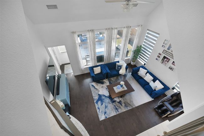 View access from the second floor to the living area featuring vaulted ceiling. | Image 16