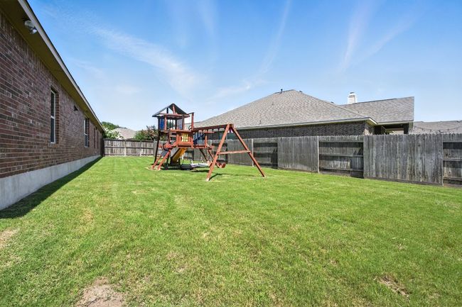 Fenced backyard with a playground | Image 36