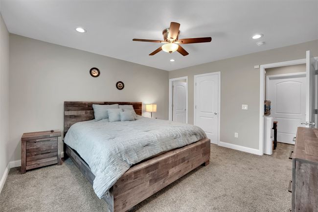 Bedroom with light carpet, ceiling fan, baseboards, and recessed lighting | Image 20