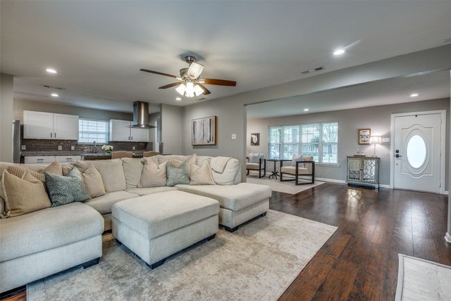 Living room with a ceiling fan, recessed lighting, and dark wood finished floors | Image 12
