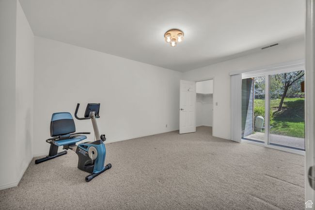 Exercise area with carpet, visible vents, and baseboards | Image 22