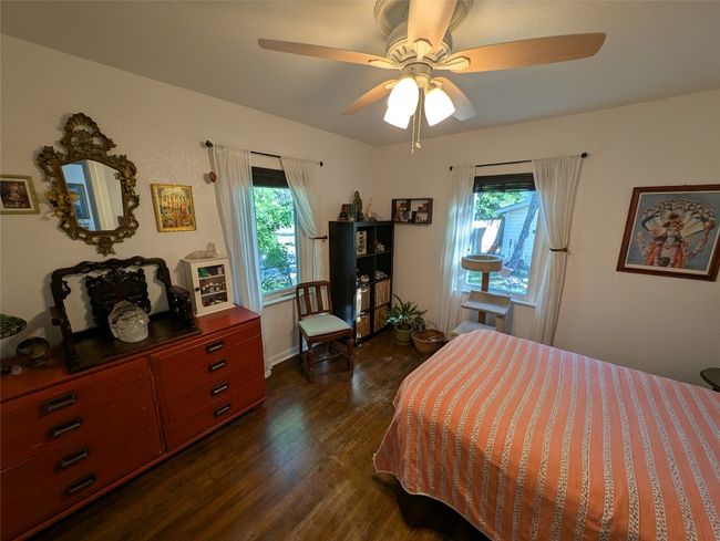 Bedroom featuring ceiling fan and dark wood-style flooring | Image 19