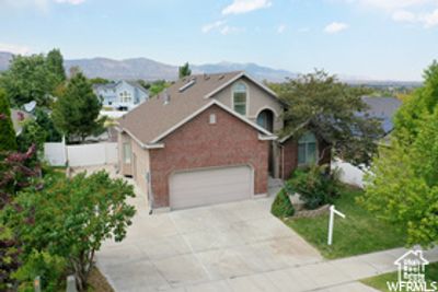 Front of property with a mountain view and a garage | Image 2