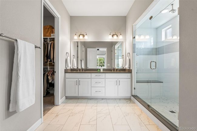 Primary spa-like ensuite with oversized shower (complete with rain shower head), linen closet and beautiful tile work. | Image 21